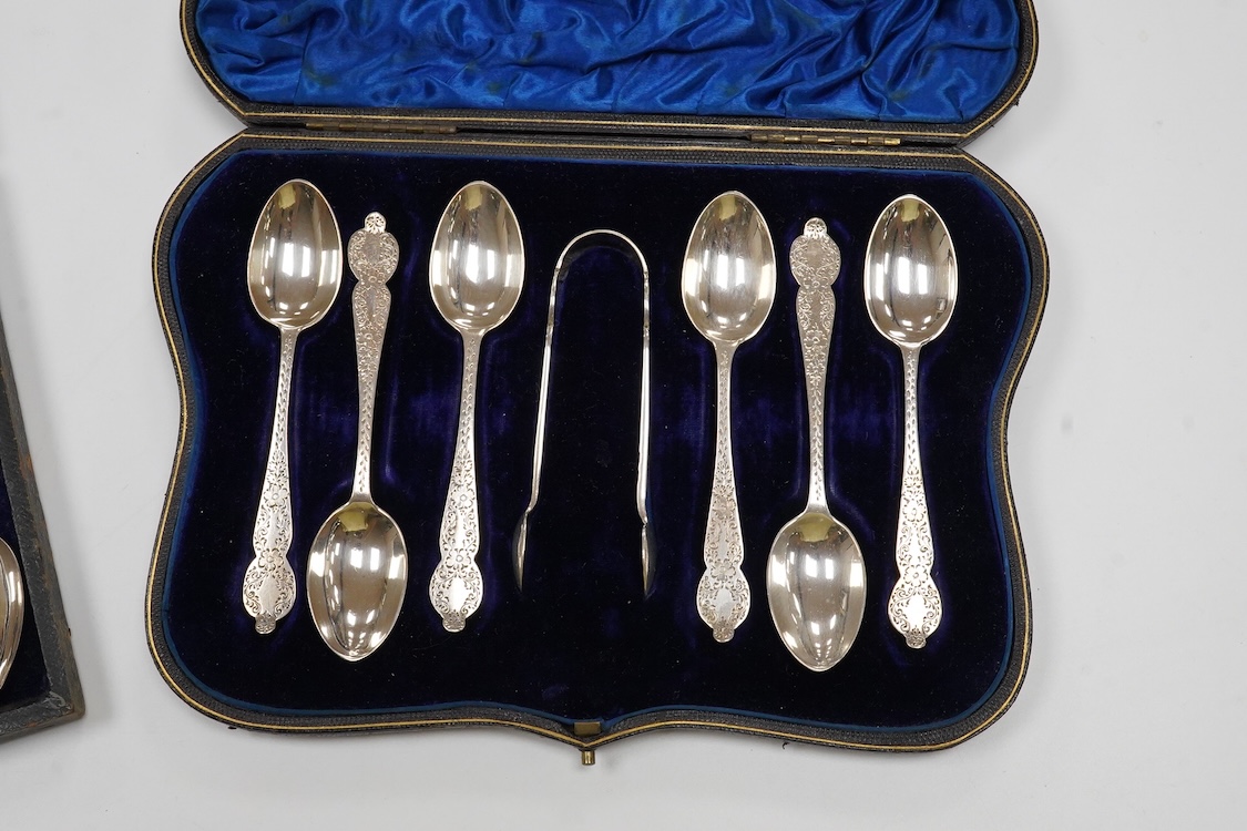 A cased set of six late Victorian engraved silver teaspoons with sugar tongs, Wakely & Wheeler, London, 1892, together with eight other silver teaspoons and a silver handled crumb brush.